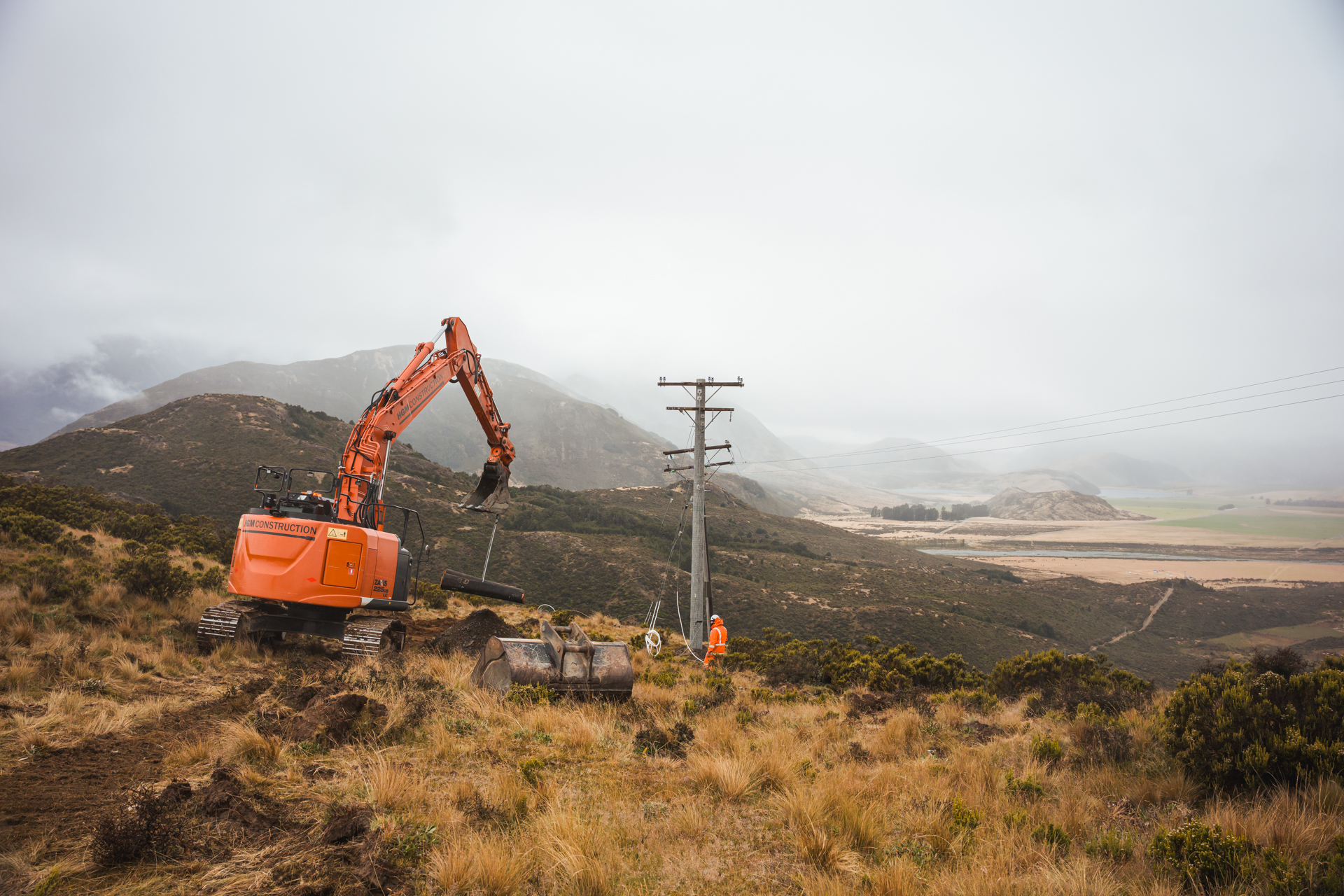 digger working on installing powerpoles at mt horrible