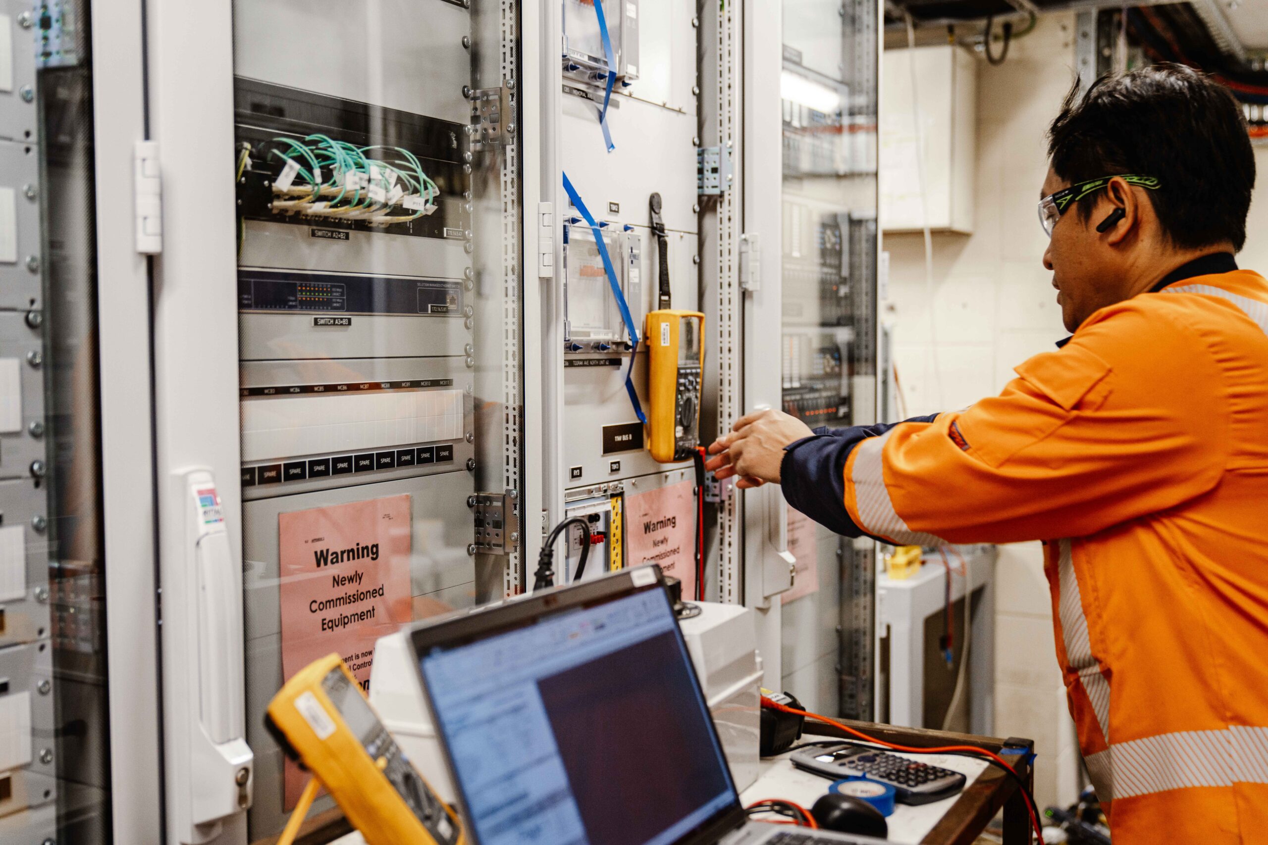 Man electrical testing inside substation