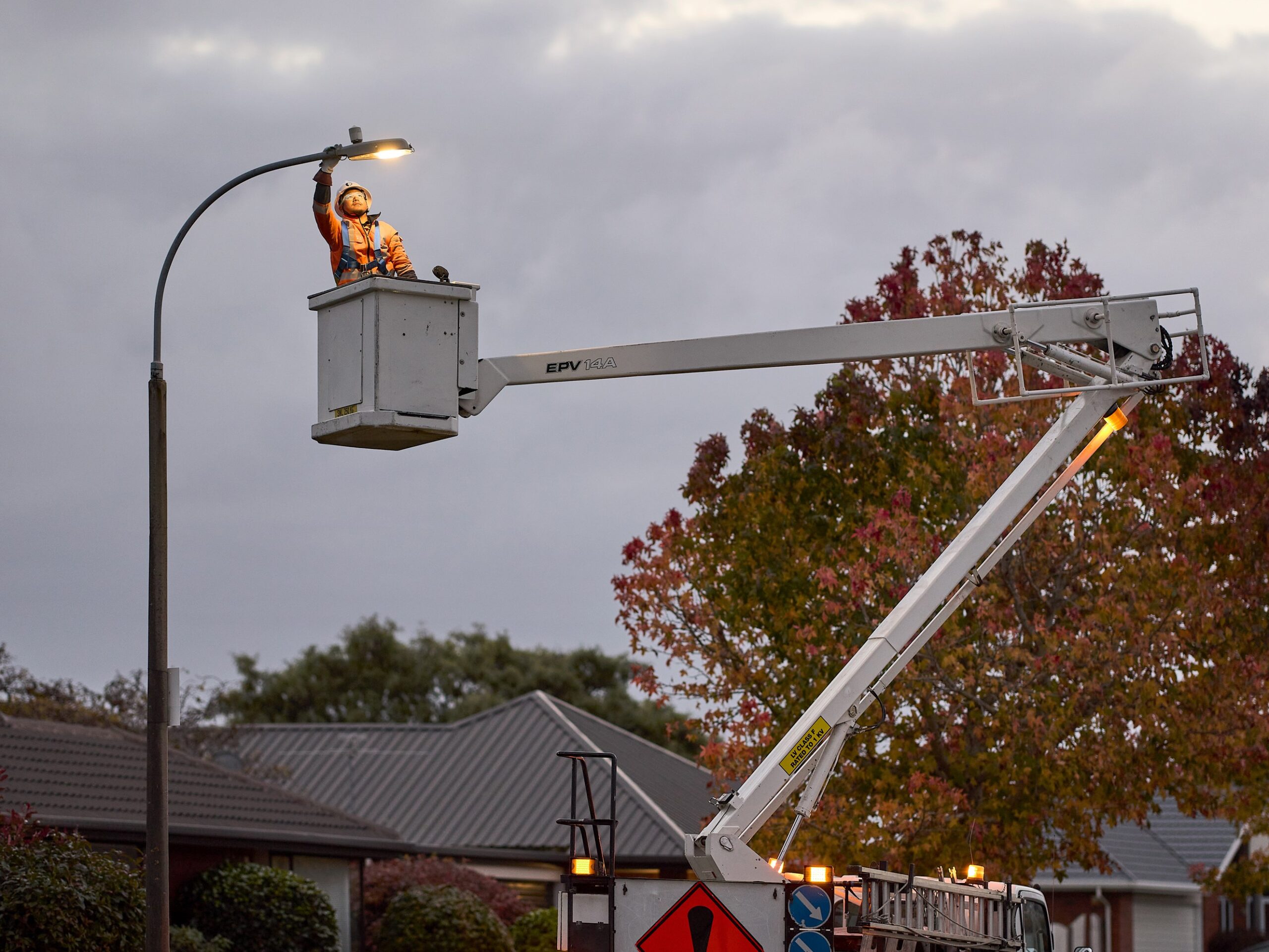 Man in bucket truck replacing LED street light