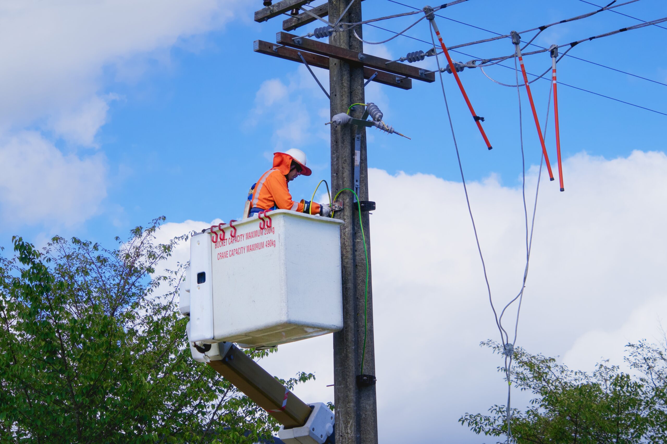 technician fixing powerpole