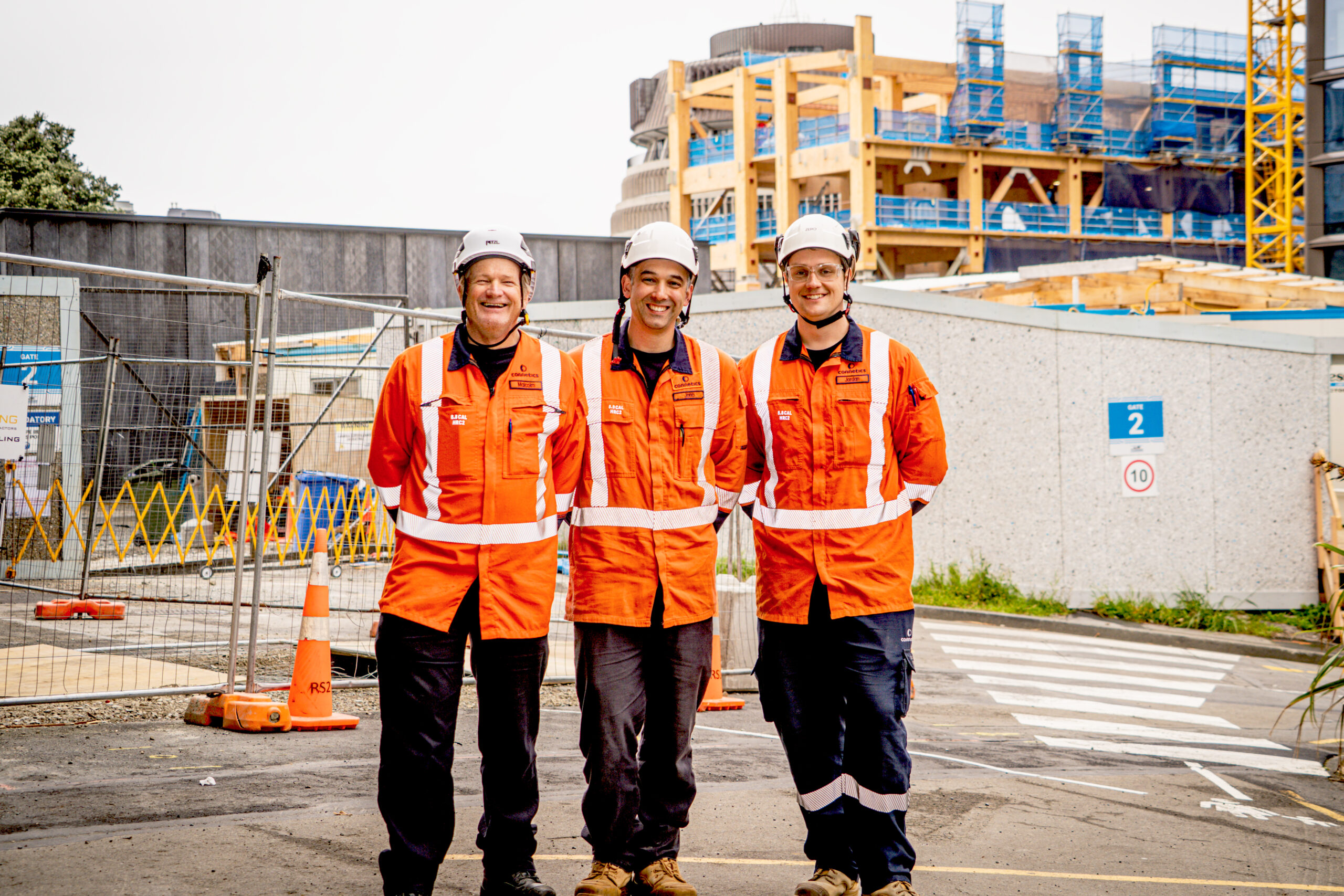 Workers smiling at camera in high vis