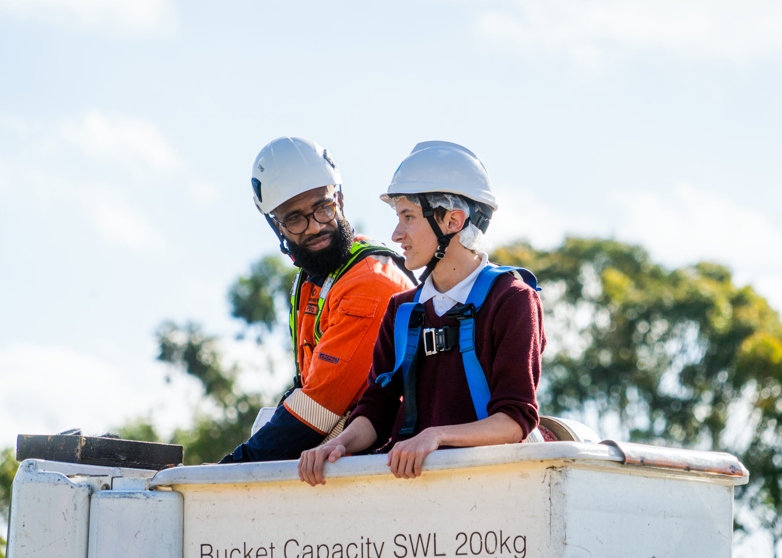 Two people in crane bucket